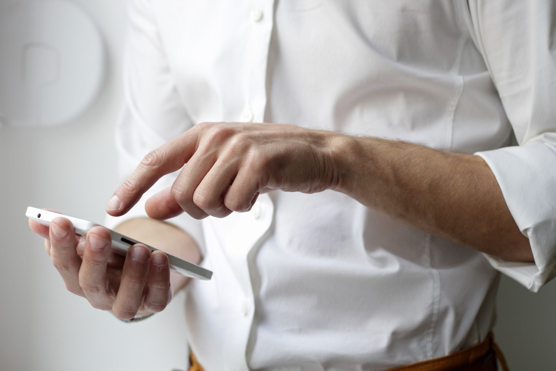 person holding white Android smartphone in white shirt